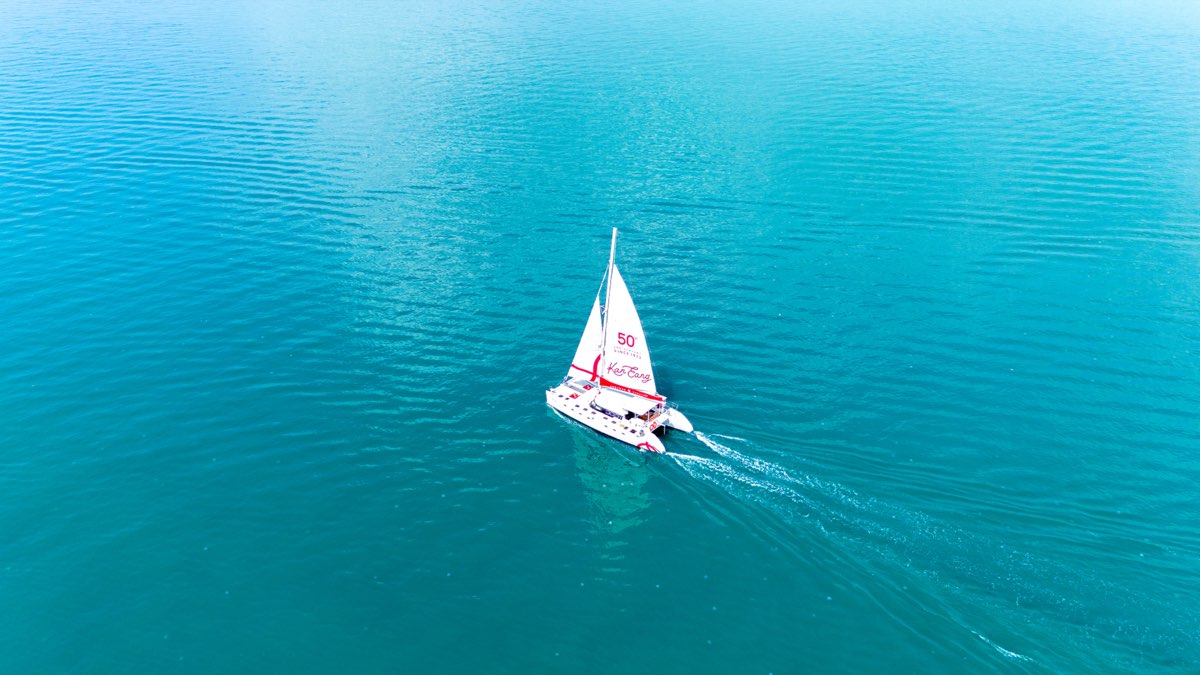 Vela Charter 62ft sailing catamaran anchored off Phuket island, aerial drone view — Andaman Signature